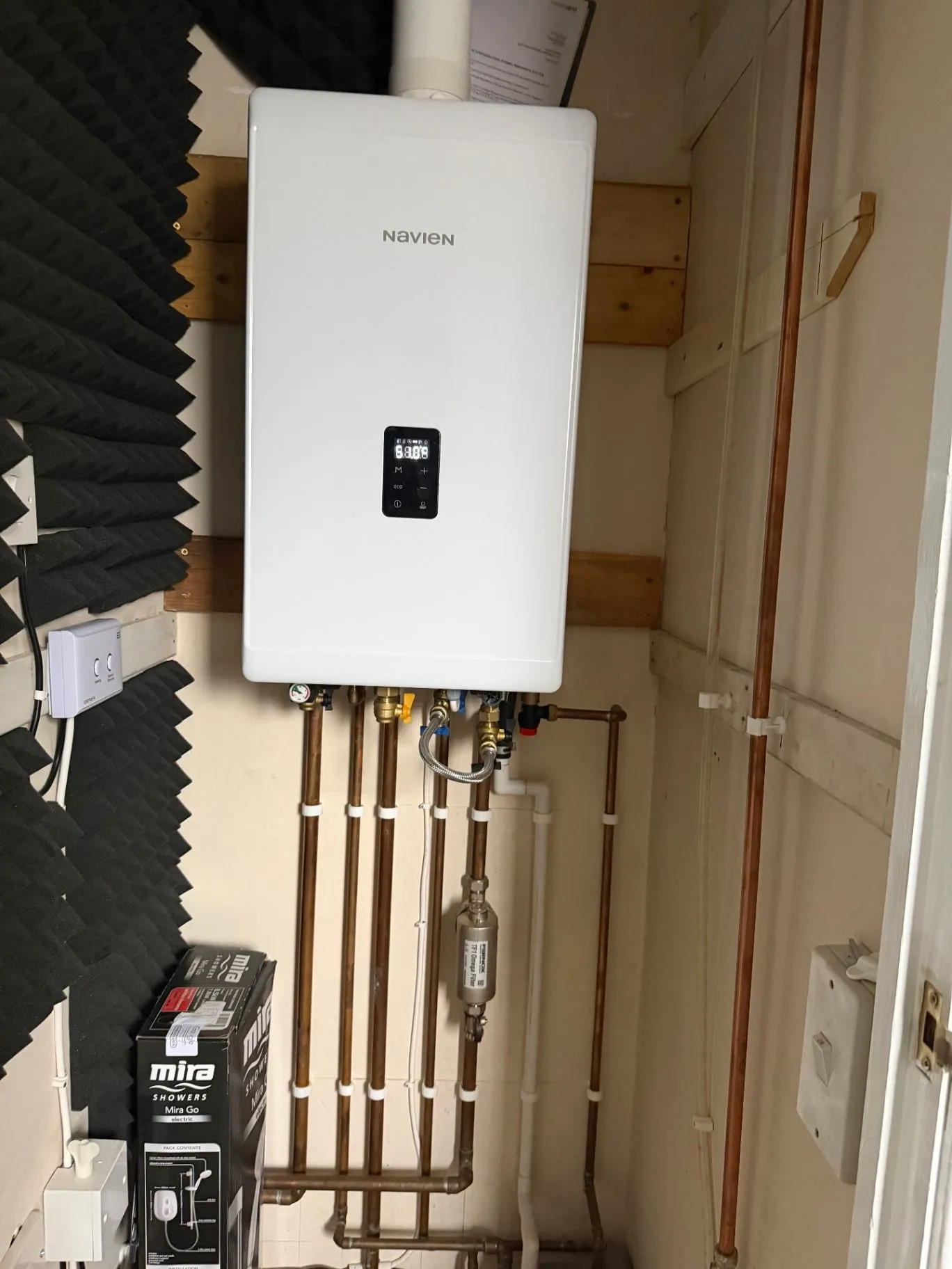 Finished wall-mounted boiler with neatly arranged copper pipework