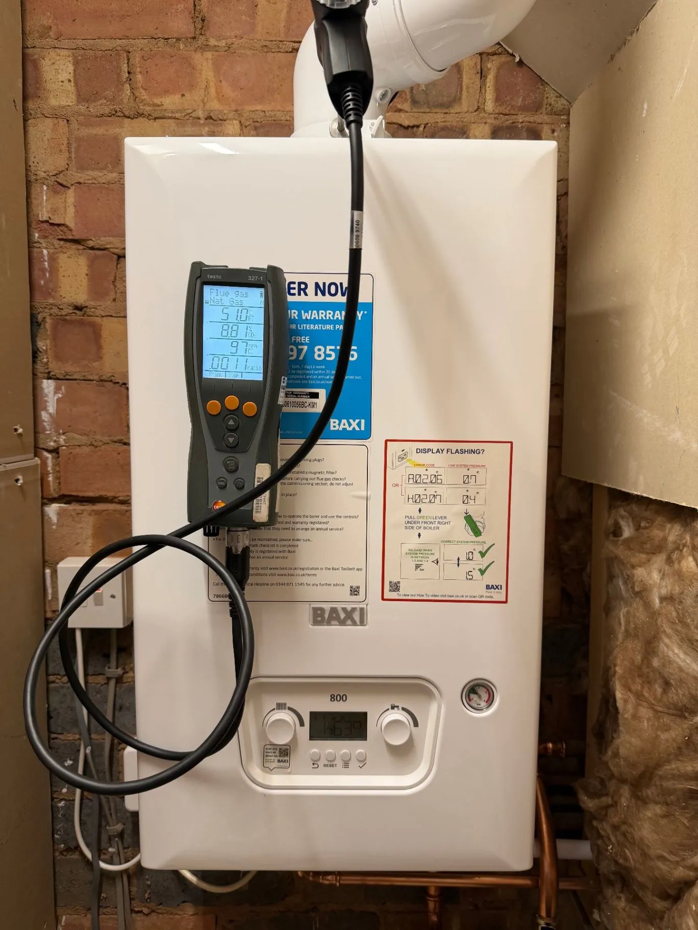 Boiler with a flue gas analyser connected during a service check